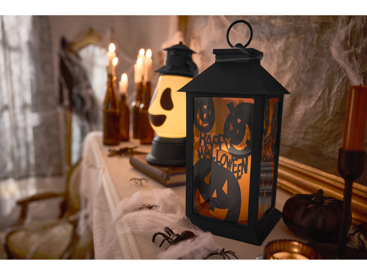 LIVARNO home LED Halloween Lantern with pumpkin cutouts and other Halloween decorations.