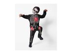 A boy in a skeleton costume with face paint, featuring red blood splatters.