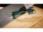 Parkside® 20V Cordless Multi-Tool cutting a textured sheet on a wooden surface.