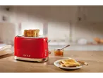 Red Silvercrest 980 W toaster with toast and jam on a wooden table.
