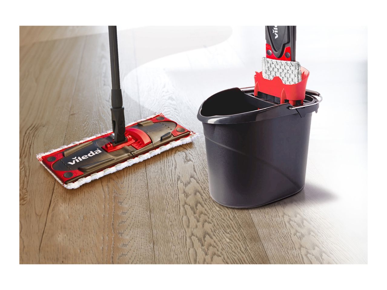 Vileda mop and bucket set on a wooden floor.
