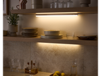 LIVARNO home Under Cabinet Light illuminating kitchen shelves with dishes and plants.