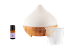 Wooden SilverCrest aroma diffuser, lavender essential oil, and measuring cup.