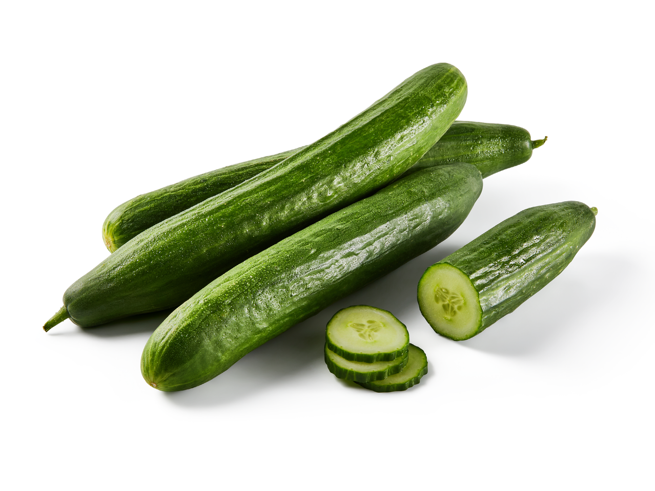 Купчина пресни краставици, една от които е нарязана на филийки.