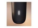 Close-up of a black cylindrical device with a glowing white vertical light strip.