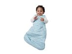 Happy baby in a blue polka dot sleep sack with white long-sleeve top.