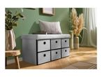 Grey storage bench with six fabric drawers, a cushion, and decorative plants in a room.