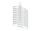 A stack of eight white plastic clothes hangers with gray rubber grips hangs from a metal hook.