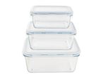 Three clear glass food storage containers with white lids, stacked from smallest to largest.
