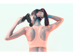 Woman using a massage gun on her neck and back.