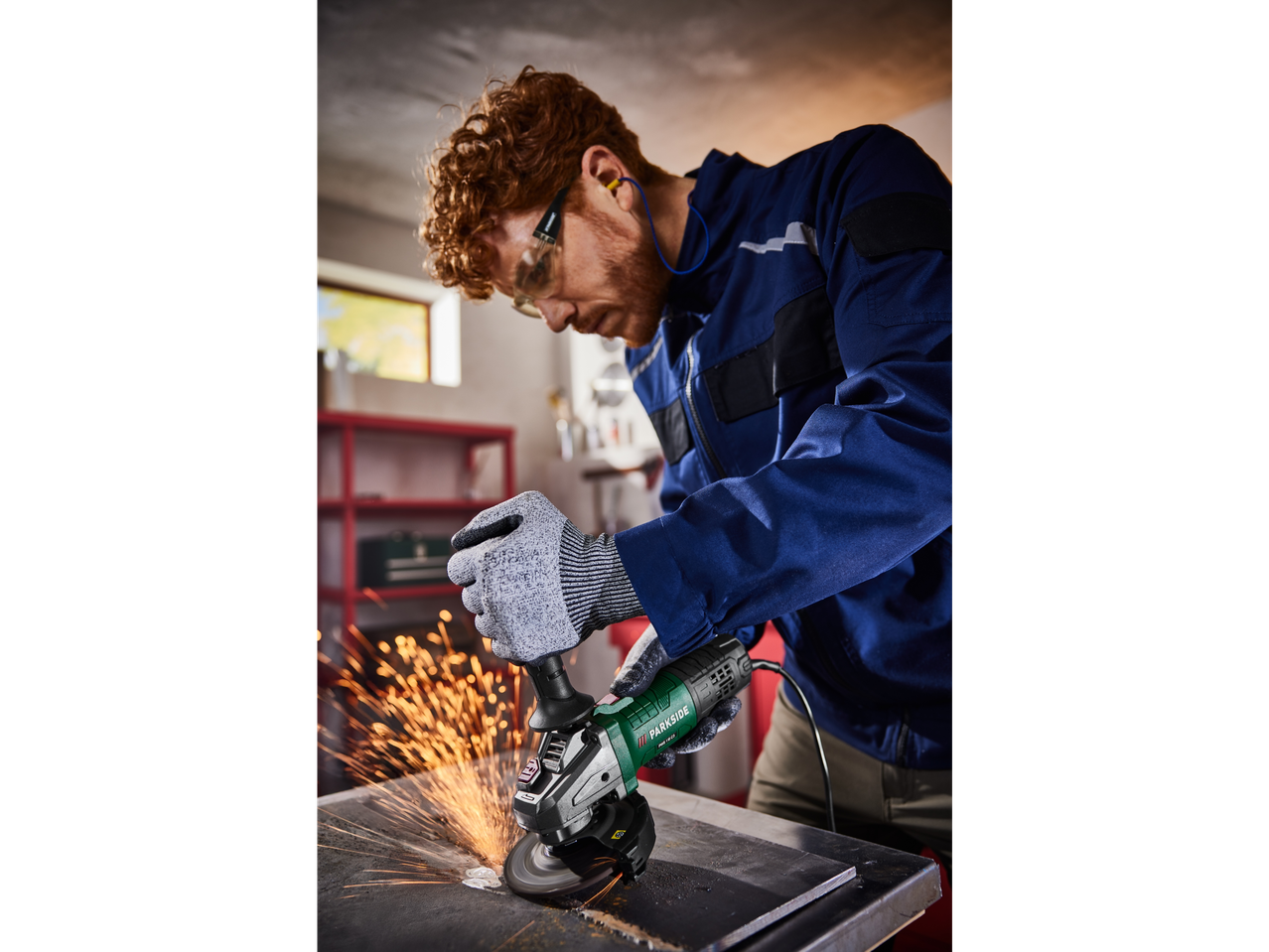 Man using a Parkside angle grinder to work metal.