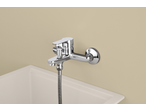 Livarno Mixer Tap Assortment: Chrome-plated wall-mounted mixer tap with a flexible hose connection above a white sink.