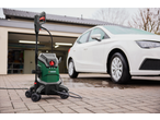 Parkside® 2000W Flexible Pressure Washer next to a white car on a paved driveway.