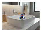 A blue rubber duck wearing a black shirt with 'FIFA World Cup 2022' and holding a soccer ball, floats in a white sink.