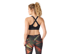Woman in black sports bra with criss-cross back straps and patterned leggings.