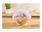 White mesh fruit bowl with a lid, filled with apples, grapes, and lemons, on a wooden counter.