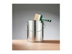 Paint can with a green-handled paintbrush resting on its rim, on a wooden surface.