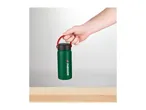 Hand holding a green Parkside water bottle with a red handle above a wooden surface.