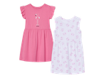 Dvije dječje haljine: ružičasta s flamingom i natpisom 'PINK DAYS', te bijela s uzorkom tukana.