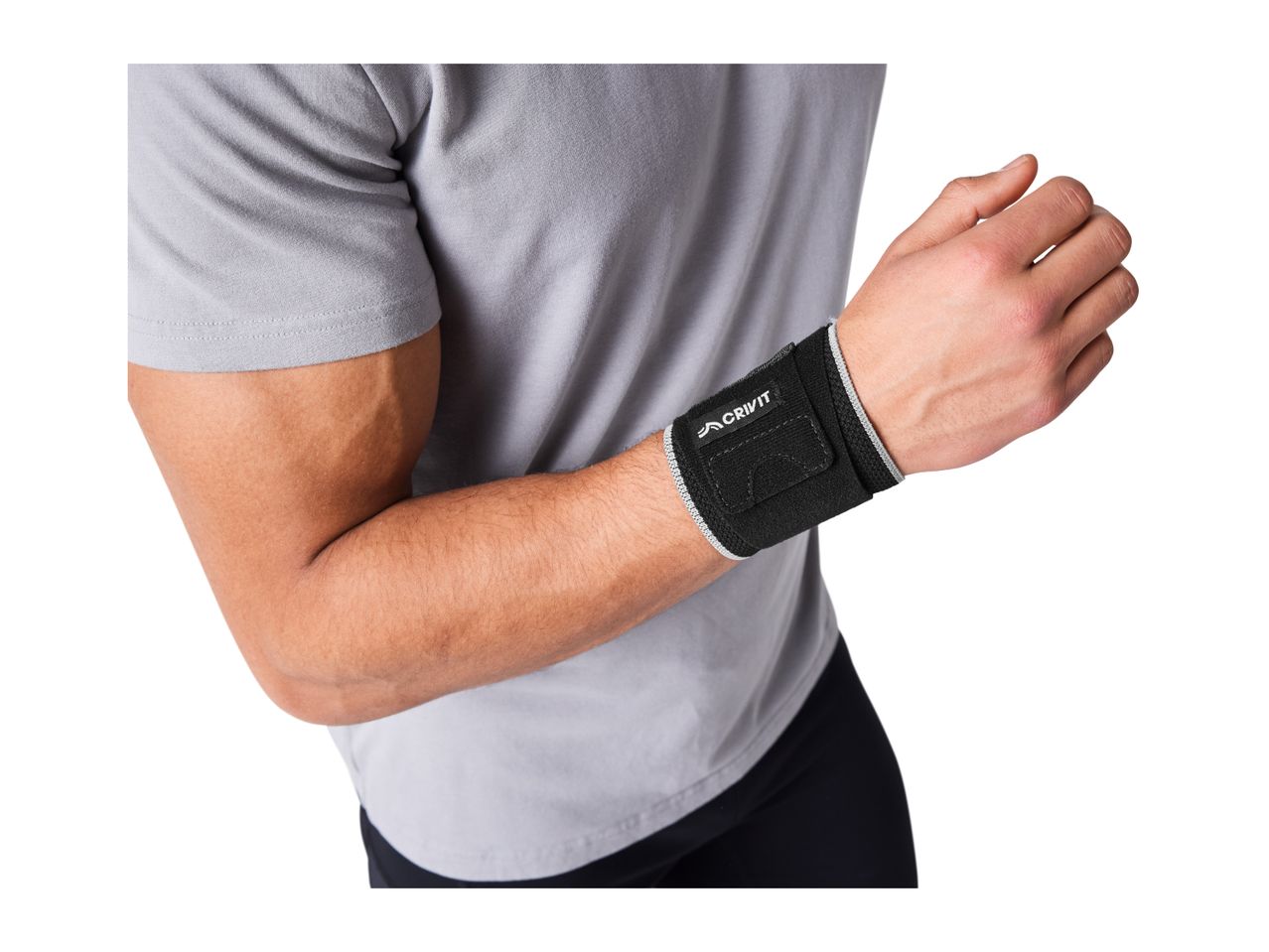 Close-up of a man wearing a black wrist support with a grey trim.