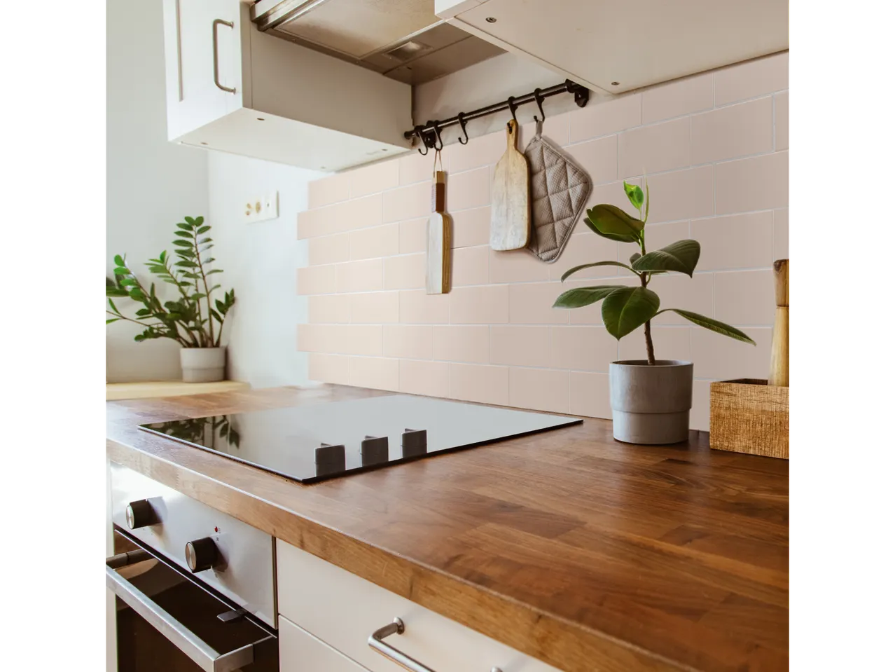 Kitchen with LIVARNO home self-adhesive wall tiles, wooden countertop, and induction hob.