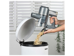 A person empties a Belray handheld vacuum into a bin.