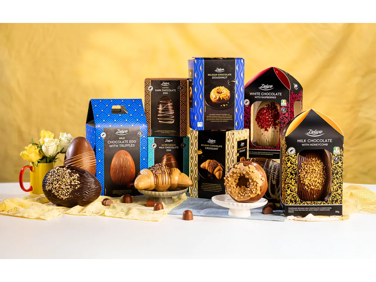 A variety of chocolate Easter eggs and chocolate-shaped treats, including doughnuts and croissants.