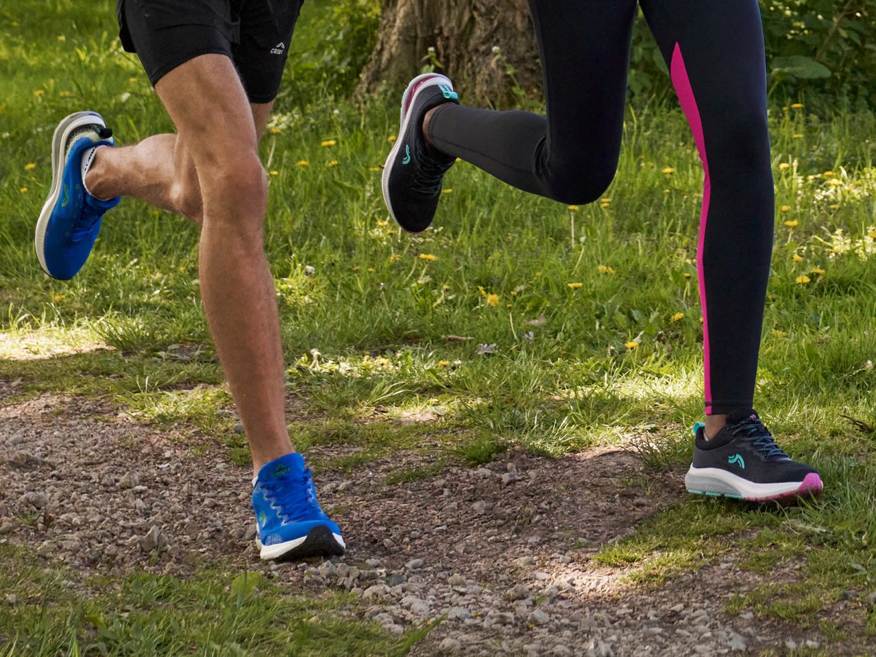 Two runners wearing Crivit running shoes jog on a trail.
