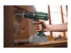 Cordless drill in use, drilling into wood, with sawdust flying around.