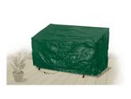 Green protective cover for garden furniture on a patio with a potted plant.