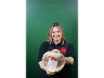 A woman holding two packaged pizza bases.