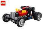 Red and black toy hot rod car with yellow engine details and grey wheels.