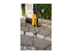 Keys hanging from a black and yellow grabber tool, with a person and paved ground in the background.