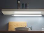 Under-cabinet LED lighting illuminates a kitchen countertop.