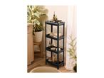 Black four-tier storage shelf with kitchen items next to a plant and wooden cabinet.