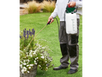 Man uses a Parkside® sprayer for plant care in the garden.