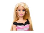 Close-up of a blonde Barbie doll wearing a pink and white striped dress.