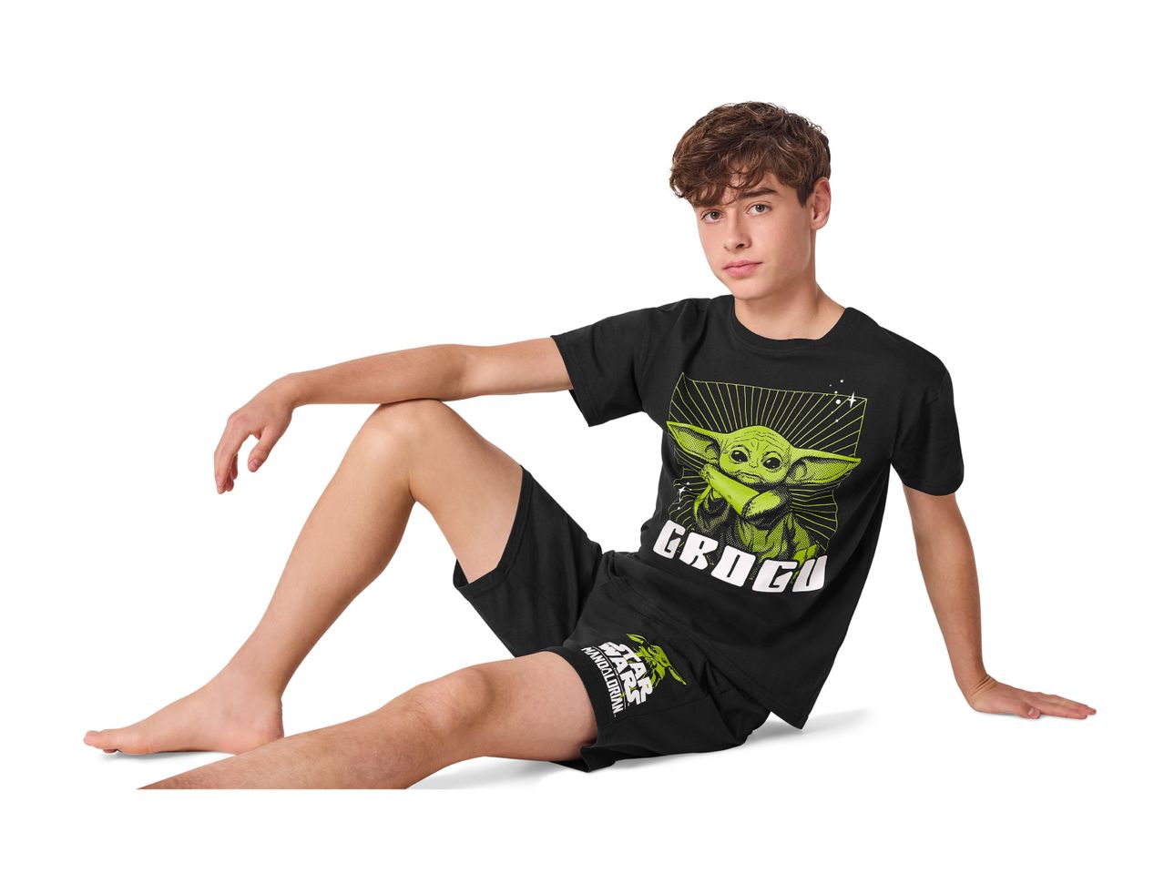 Boy in black Grogu pyjamas, featuring a large Grogu print on the t-shirt.