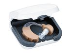 Hearing aid in an open white and dark grey case.