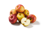 A pile of fresh red and yellow apples, one cut in half, on a white background.
