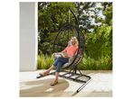 Woman relaxing in a garden hanging chair.