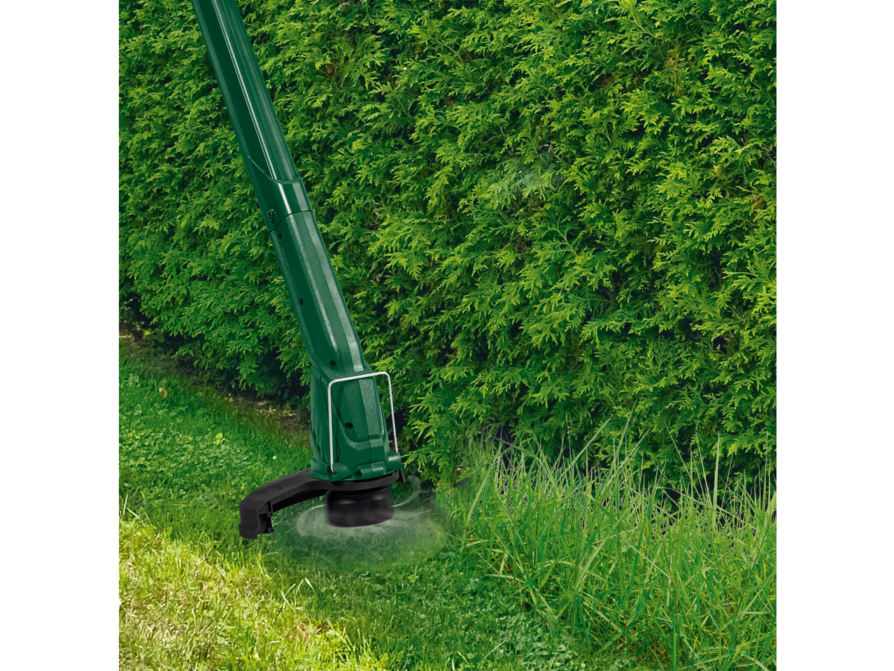 PARKSIDE® 300W Electric Lawn Trimmer cutting grass next to a green hedge.