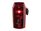 A red See.Sense bike light with visible circuitry and a lit LED.