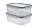Two clear rectangular food storage containers with blue-grey lids, stacked on a white background.