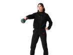 Woman in black Crivit tracksuit with a kettlebell.