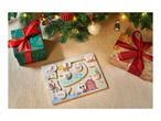 Christmas gifts and a farm animal puzzle on a beige blanket under a Christmas tree.