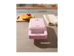 Pink SilverCrest waffle maker on a kitchen counter with waffles.
