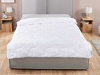 A white duvet cover is neatly placed on a gray bed frame.