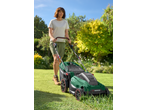 Woman mowing lawn with a green PARKSIDE® 40V Cordless Lawn Mower.