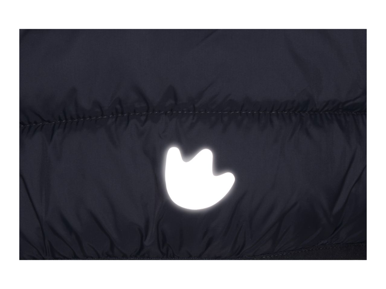 Close-up of a dark blue puffer jacket with a reflective paw print detail.